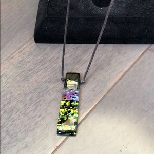 Pendant necklace on rope chain.